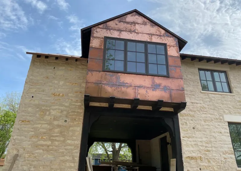 Copper metal panel facade on a stone building for Roof Repair in Santa Barbara